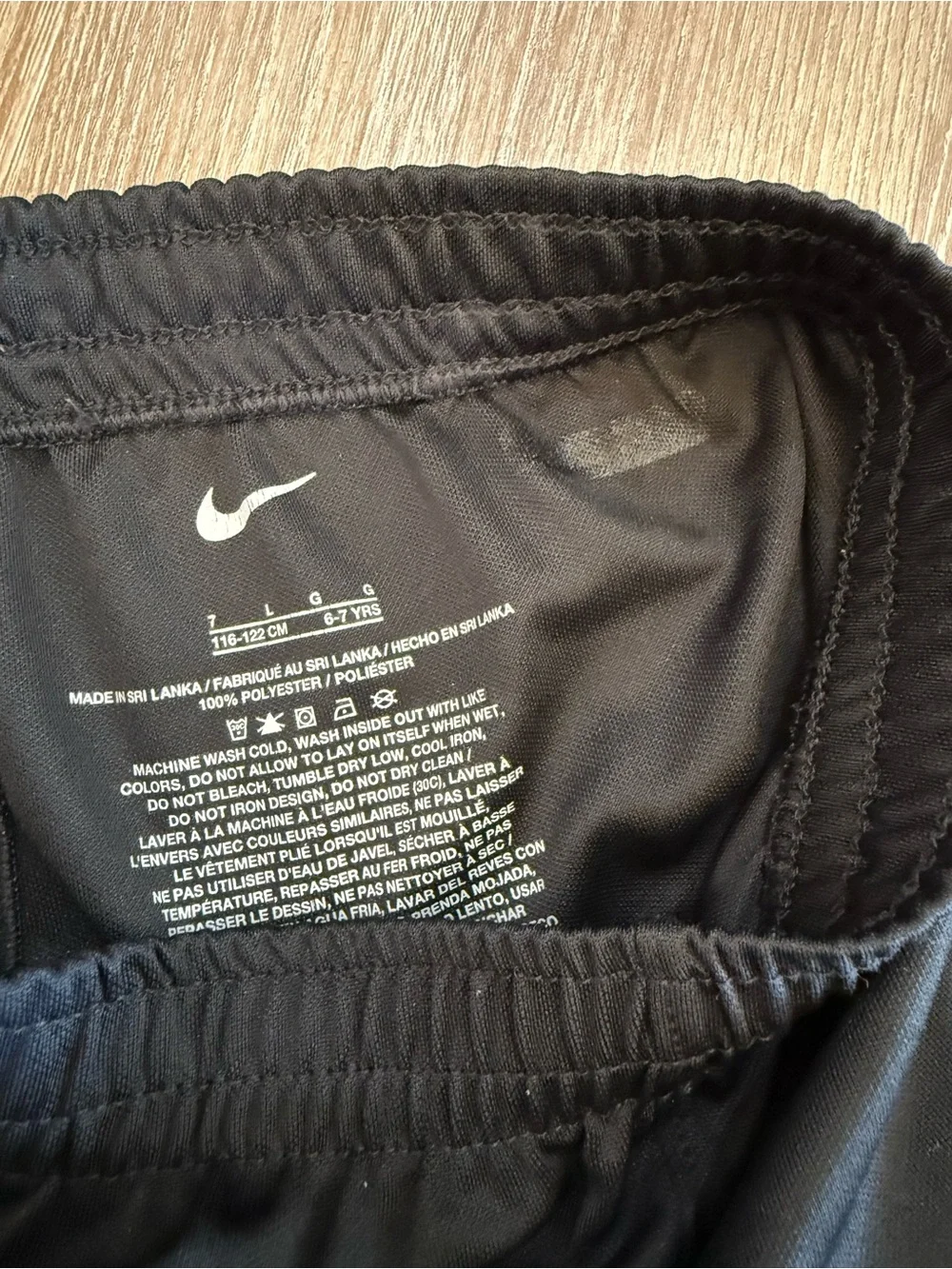 Boys Nike Black Athletic Shorts with Yellow Swoosh - size 7 (L)